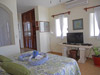 Master bedroom has king-sized bed, ceiling fan, A/C and flat-screen TV with DVD.
