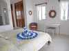 Master bedroom has king-sized bed, ceiling fan, and A/C.