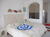 Master bedroom has king-sized bed, ceiling fan, and A/C.