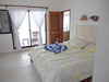 Master bedroom has sliding glass doors opening to balcony.