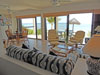 Living room has an open floor plan with glass doors opening to the covered patio.